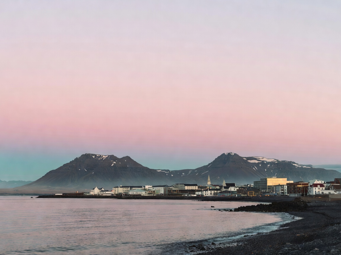 Reykjavik coastline and volcanic mountains during white nights civil twilight