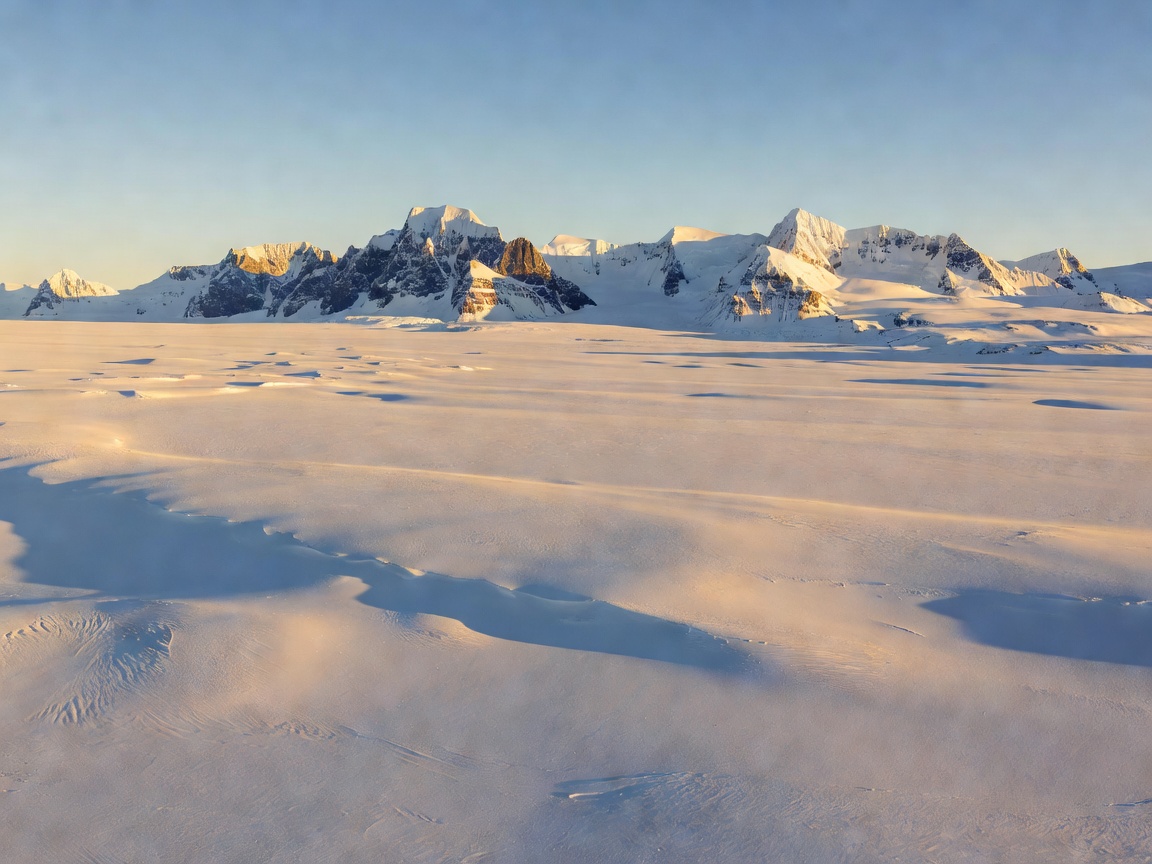 Svalbard ice plateau and dramatic peaks bathed in non stop polar sun